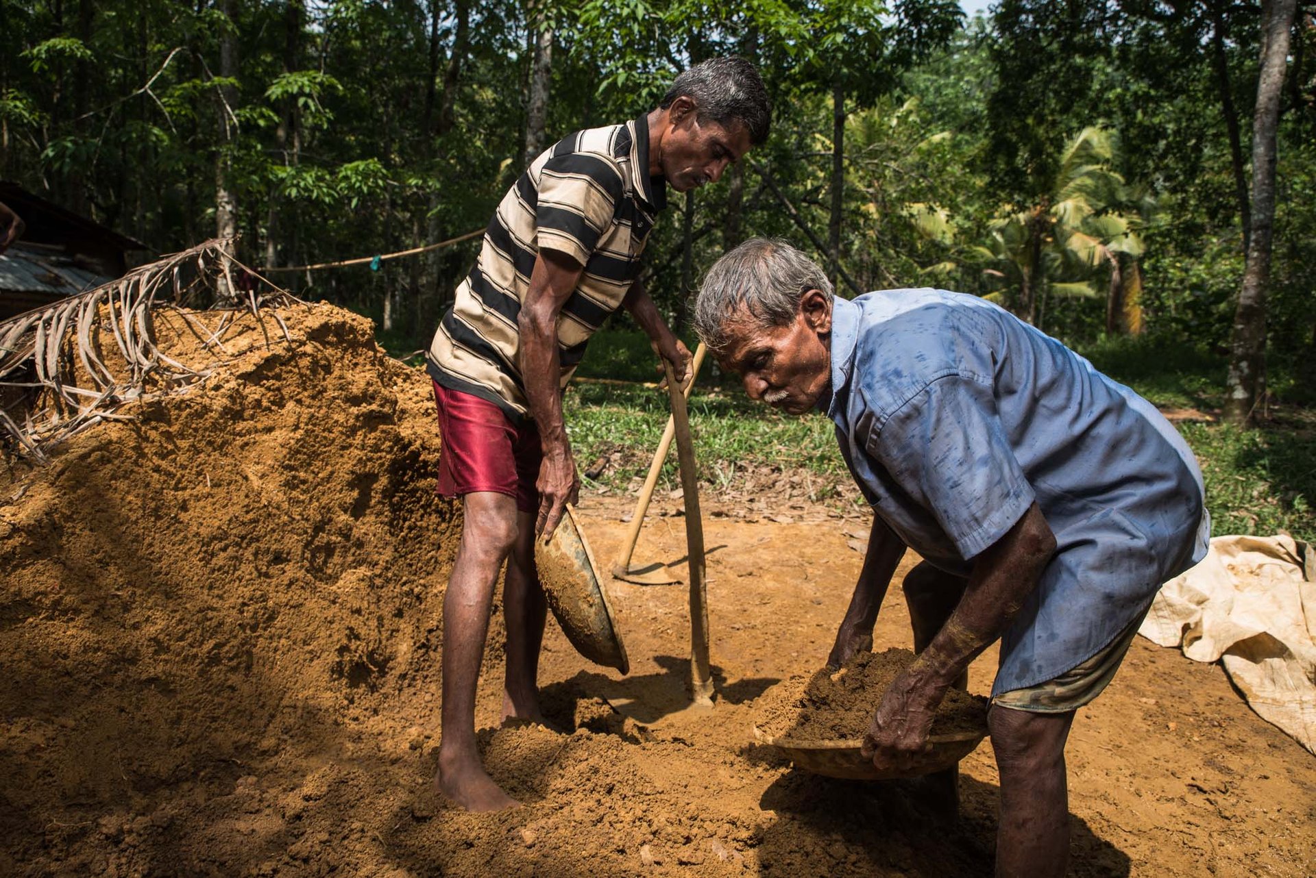 Miners washing gravel for gemstones by hand